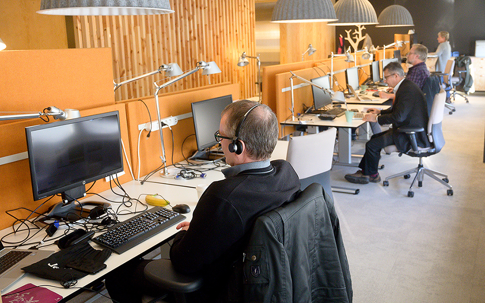 Two people working at computers in the office.