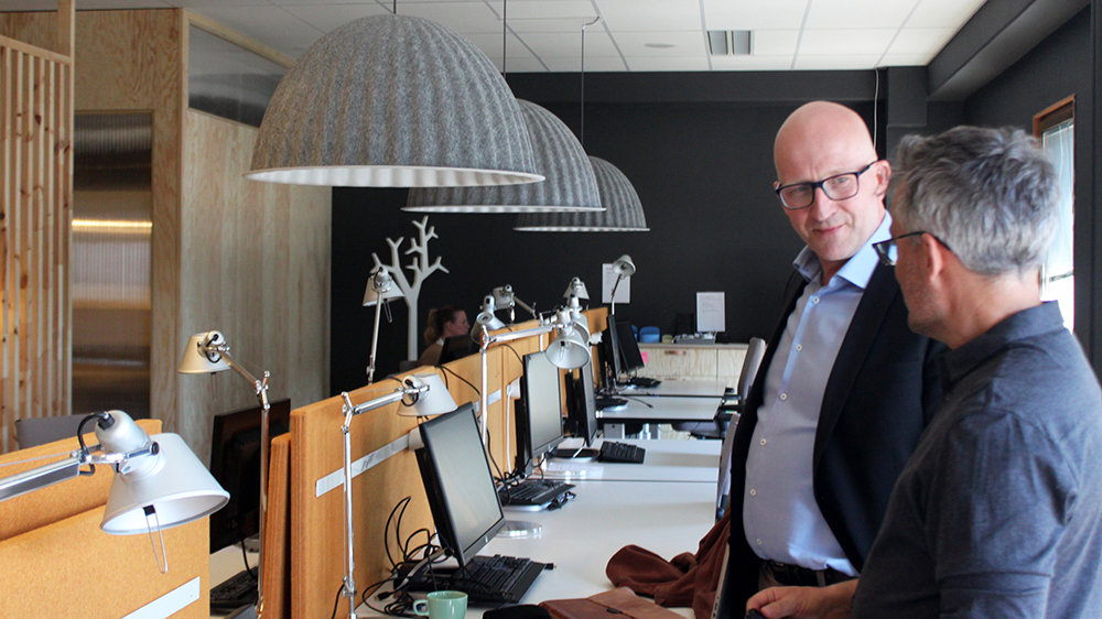 Two men talking in an office.